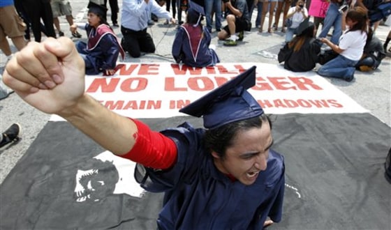 A protester blocks a street during a rally protesting Georgia's new immigration law on the Capitol steps Monday, June 28, 2011 in Atlanta. Six young illegal immigrants were arrested after they sat down in an intersection next to the Georgia Capitol blocking traffic to protest state policies targeting illegal immigration. (AP Photo/John Bazemore)